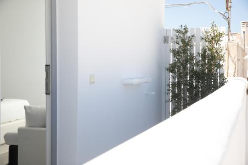 a door leading into a living room with a plant at Kamvas Deluxe Apartments in Naxos Chora