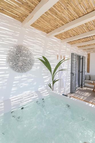 a swimming pool in a house with a ceiling at Kamvas Deluxe Apartments in Naxos Chora