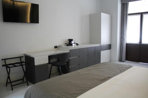 a bedroom with a bed and a desk and a table at Hotel Boutique Casona de Santa Clara in Puebla
