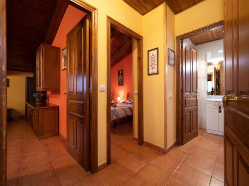 a hallway with doors and a room with a bed at Turismo Rural Castell in Neril