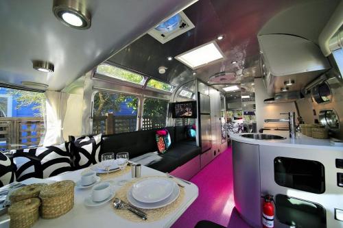 an rv with a table and chairs and a kitchen at metro hotel in Petaluma