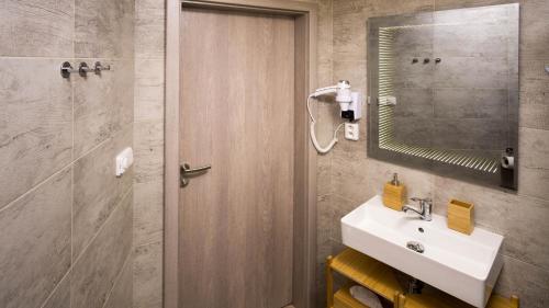 a bathroom with a sink and a mirror at Flying Bed Apartment close to Prague Castle and Airport in Prague