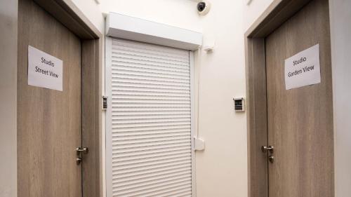 a pair of doors in a building with signs on them at Flying Bed Apartment close to Prague Castle and Airport in Prague