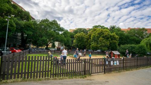 a group of people in a park behind a fence at Flying Bed Apartment close to Prague Castle and Airport in Prague