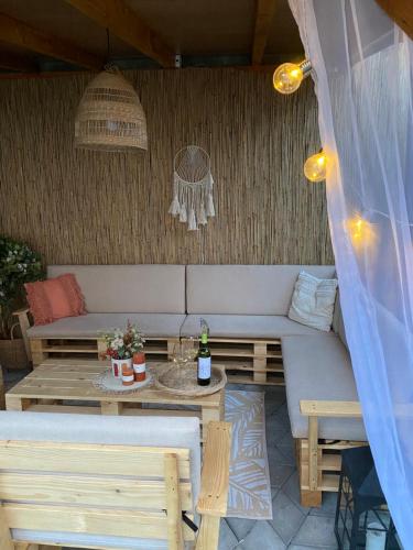 a patio with a couch and a table at Apartmani Lazarevic Jagodina in Jagodina