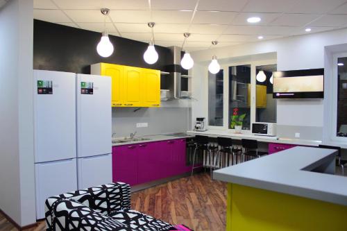 a kitchen with purple and yellow cabinets and appliances at HD Hostel Izhevsk in Izhevsk