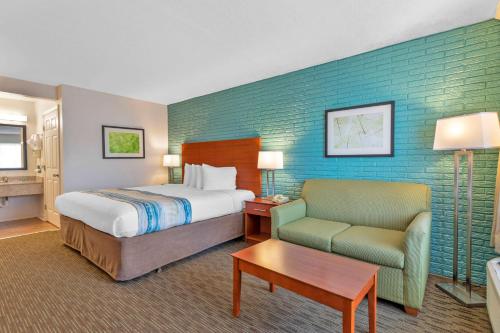 a hotel room with a bed and a chair at Best Western Hendersonville Inn in Hendersonville