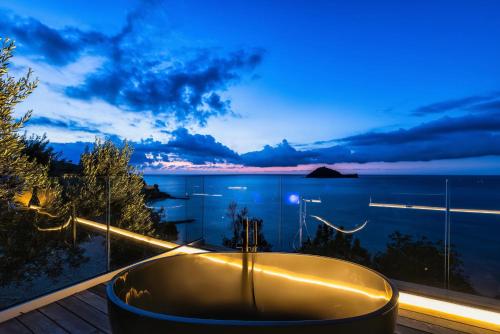 a bath tub on a balcony with a view of the ocean at Baba Residences in Alassio