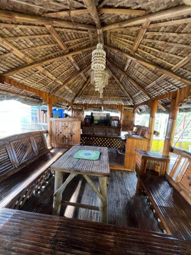 a dining room with a wooden table and benches at INN D’ZaireH in Molino
