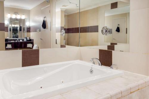 a large white bath tub in a bathroom at BEST WESTERN PLUS Poconos in Tannersville