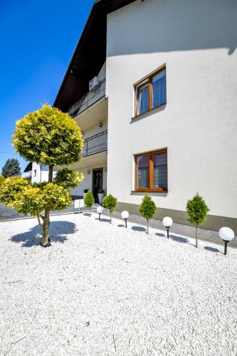 a building with trees in front of it at Apartamenty Majka in Zator