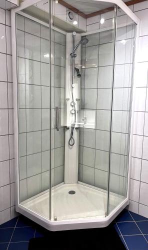 a shower with a glass door in a bathroom at Cozy Landscape House, Near pulpit Rock in Strand