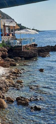 a restaurant on the shore of a body of water at Elgina Apartments2 MANI in Mína