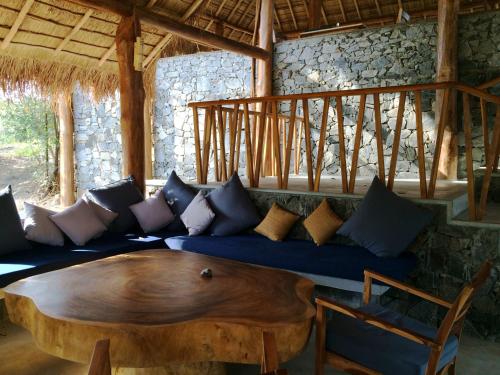 a living room with a blue couch with a wooden table at Gal Oya Lodge in Galgamuwa