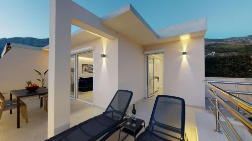 a balcony with chairs and a table with a view at Luxury Penthouse Adriatic Blue - On the beach in Tučepi
