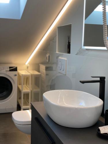 a bathroom with a large white bowl sink on a counter at Luxury Penthouse Adriatic Blue - On the beach in Tučepi