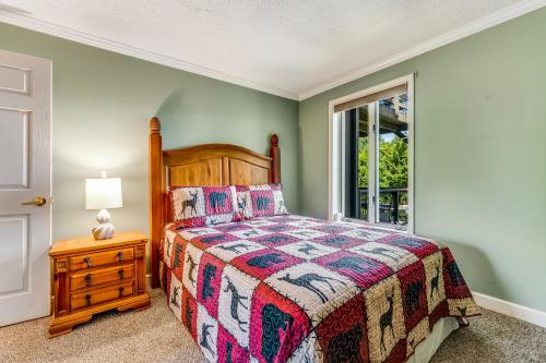 a bedroom with a bed and a window at Skyleaf Retreat in Sugar Mountain