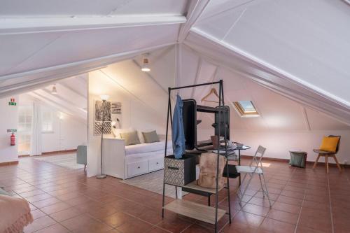 a living room with a couch and a tv in a attic at Vila Boa Vista by An Island Apart in Funchal