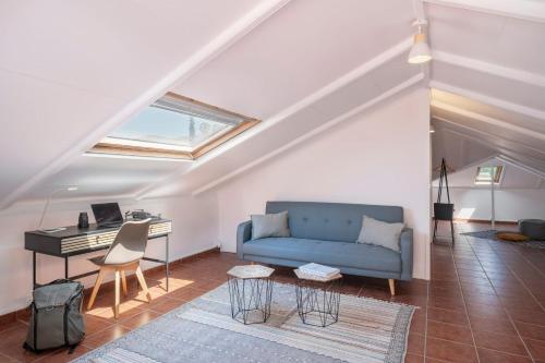 a living room with a blue couch and a piano at Vila Boa Vista by An Island Apart in Funchal