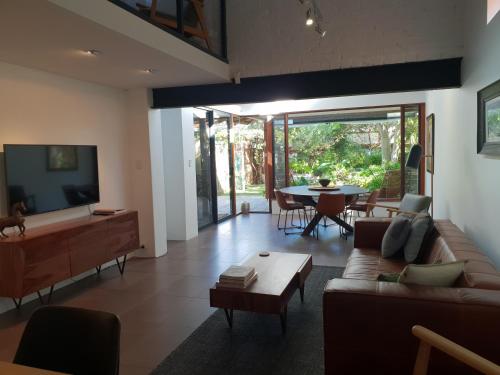 a living room with a couch and a table at The Sanctuary - garden oasis in South Fremantle in South Fremantle