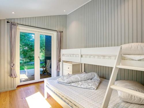 a bedroom with two bunk beds and a window at Holiday home Gilleleje LXXXIII in Gilleleje