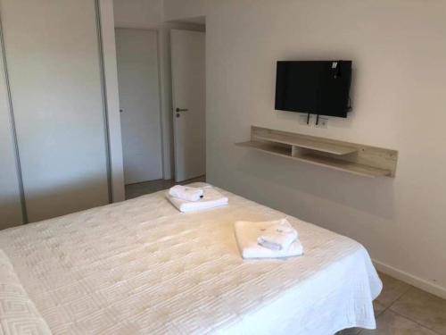 a bedroom with a bed with two towels on it at Duna 6 in Mar de las Pampas