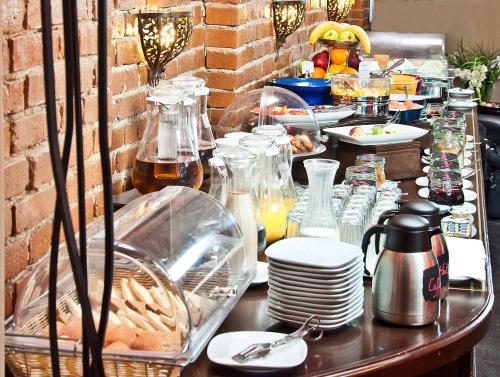 a table with plates of food on it at MOXA Bucharest Boutique Hotel in Bucharest