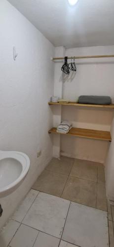a bathroom with a sink and a toilet in a room at Parrot House San Antonio in Cali