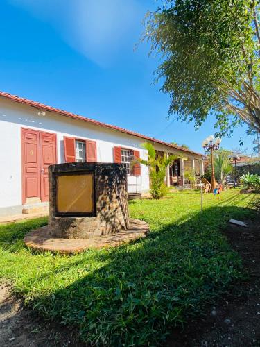 a stone fireplace in front of a house at POUSADA CHARLOTTE in Tiradentes