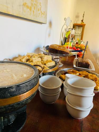 a table with a bunch of food on it at POUSADA CHARLOTTE in Tiradentes