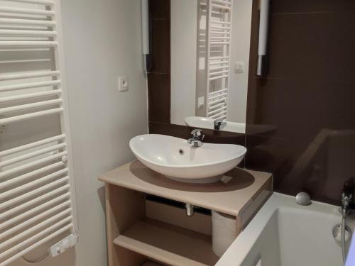 ein Badezimmer mit einem weißen Waschbecken und einem Spiegel in der Unterkunft Appartement Jausiers, 3 pièces, 6 personnes - FR-1-165B-20 in Jausiers