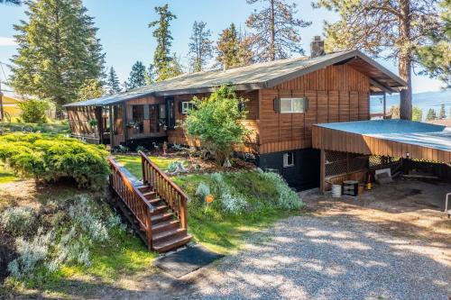 a house with a staircase leading up to it at Hilltop Hideaway in Bigfork