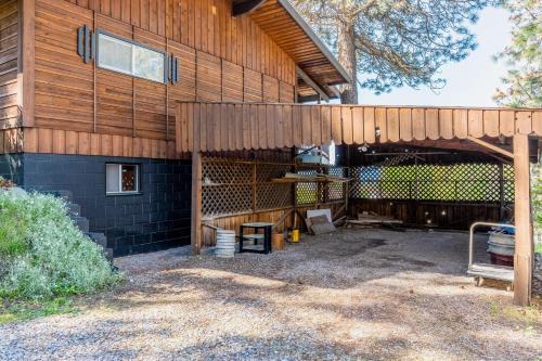 a wooden building with a bench in front of it at Hilltop Hideaway in Bigfork