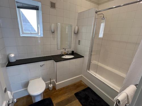 y baño con aseo, ducha y lavamanos. en Centrally located 1-Bed apartment in Inverness en Inverness