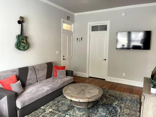 a living room with a couch and a table at Cozy & Quiet Two Bedroom Condo In The Heart Of Historic St. Augustine in Saint Augustine