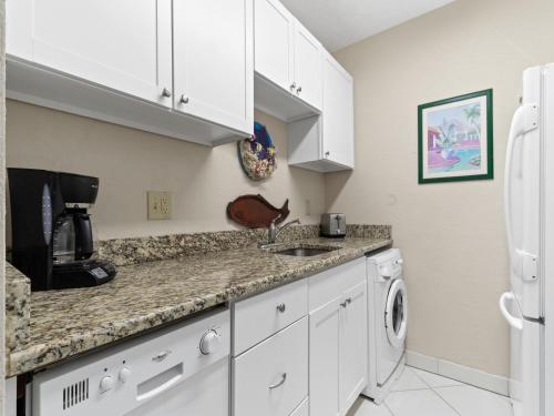 a kitchen with white cabinets and a sink at 1 Bedroom at Madeira Beach Yacht Club 165C in St Pete Beach