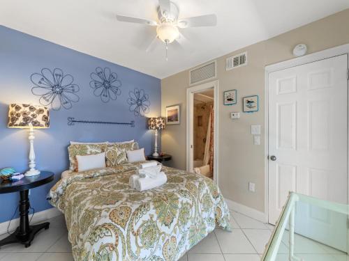 a bedroom with a bed and a ceiling fan at 1 Bedroom at Madeira Beach Yacht Club 165C in St. Pete Beach