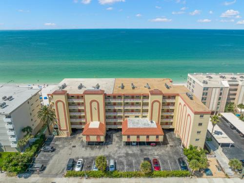 an aerial view of a hotel with the ocean in the background at Las Brisas 306 in St Pete Beach