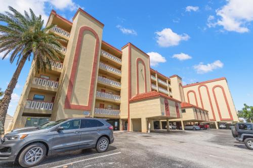 a car parked in a parking lot in front of a building at Las Brisas 306 in St Pete Beach