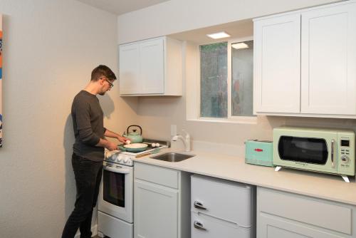 a man standing in a kitchen preparing food at Hotel McCoy Pullman in Pullman