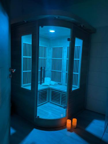 a dark room with a shower with a mirror at RITUAL in Ajdovščina