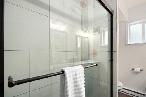 a bathroom with a glass shower with a towel at Hotel McCoy Pullman in Pullman
