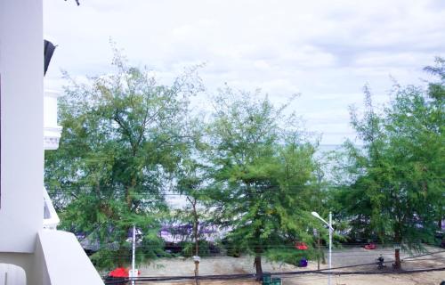 a view from a window of a park with trees at GOLDEN GUESTHOUSE by The Beach Cha Am in Cha Am
