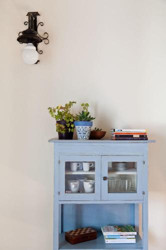 a blue cabinet with dishes and plants on it at Molino Monacelli Country House in Fano