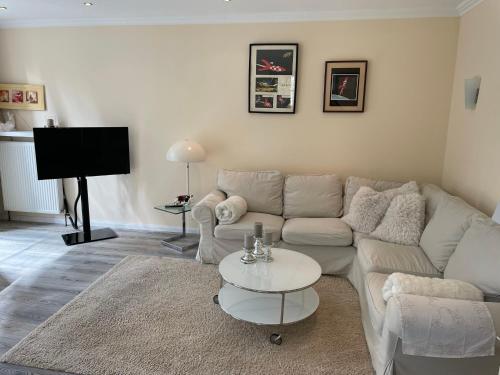 a living room with a couch and a table at Apartment Ammersbek in Ammersbek