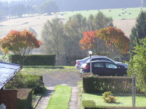 a car parked in the driveway of a house at Guest house Mückenheim in Benneckenstein
