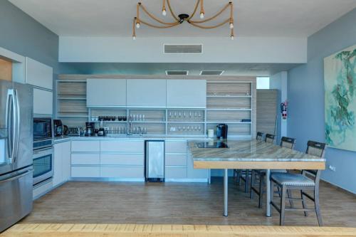a kitchen with a table and chairs and a refrigerator at Happy Days Villa C in Fajardo