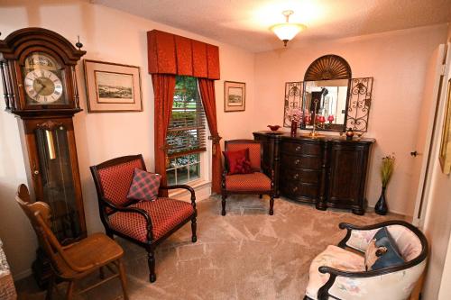 a living room with a grandfather clock and chairs at Comfortable Luxury, Superior Quality, Two Bedrooms in Mobile