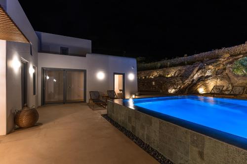 a swimming pool in a villa at night at Cape Ftelia in Elia
