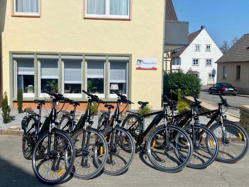 a group of bikes parked in front of a building at Gästehaus am Kurpark Hotel Garni in Horn-Bad Meinberg